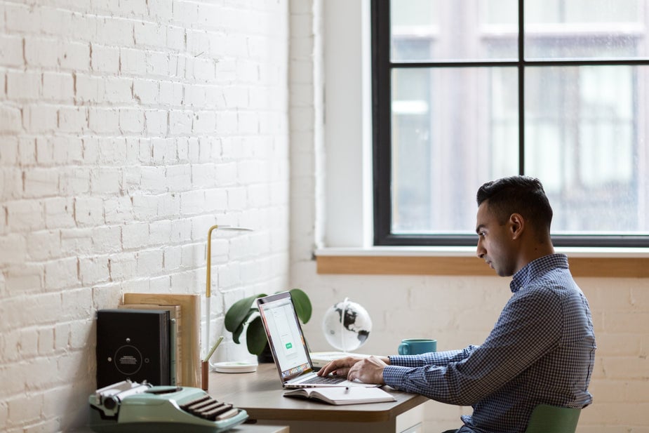 young-man-working-at-desk-in-credit-union young-man-working-at-desk-in-credit-union